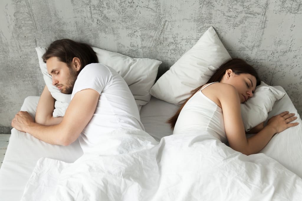 Couple Sleeping On Bed